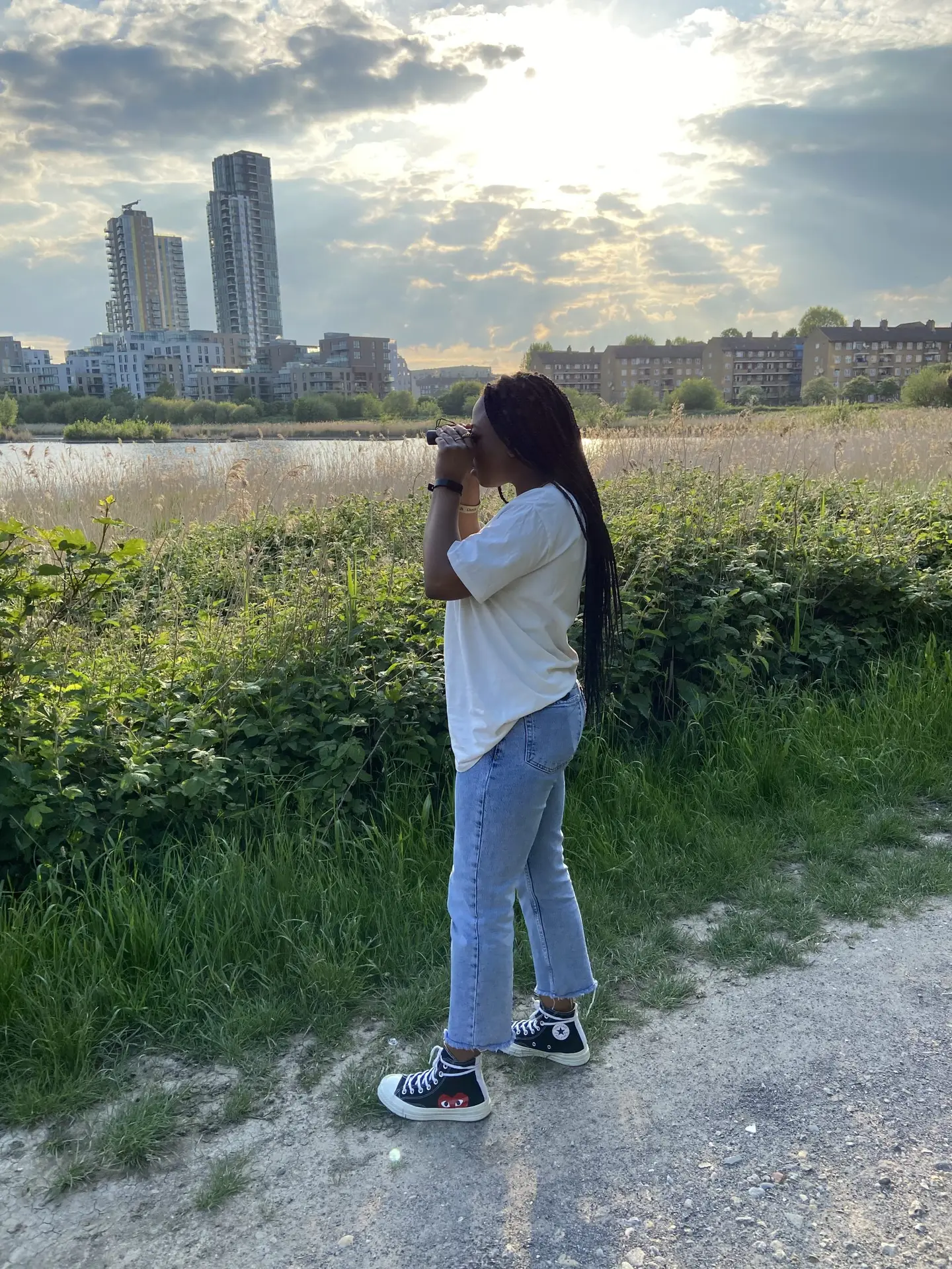 An image of Francisca  bird watching looking through binoculars
