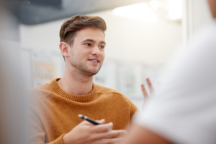 A young person speaking to people during a training.